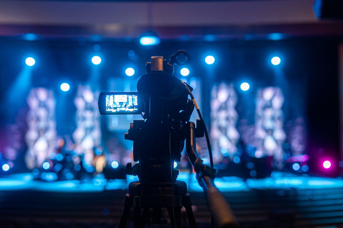 A camera filming a stage during a live production